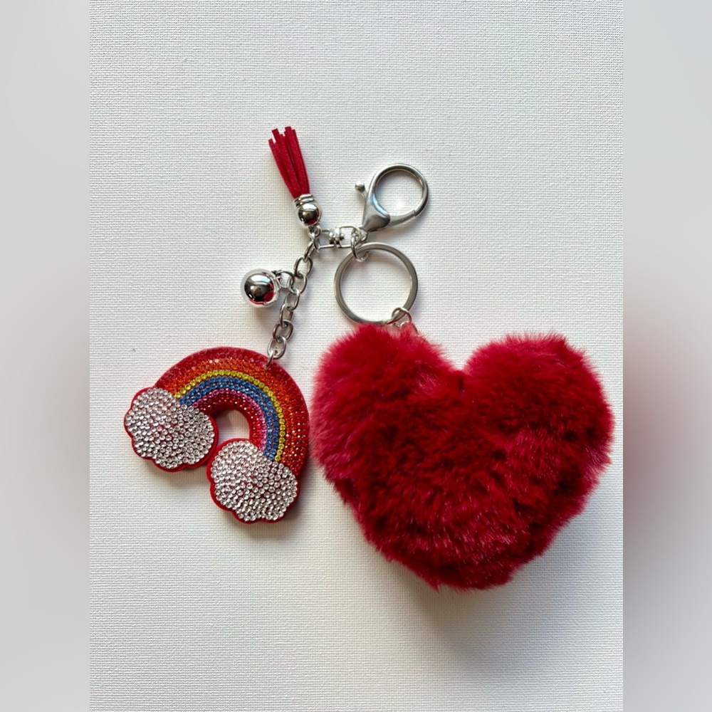 Keychain with a red and rainbow heart-shaped pompom with a red suede tassel.